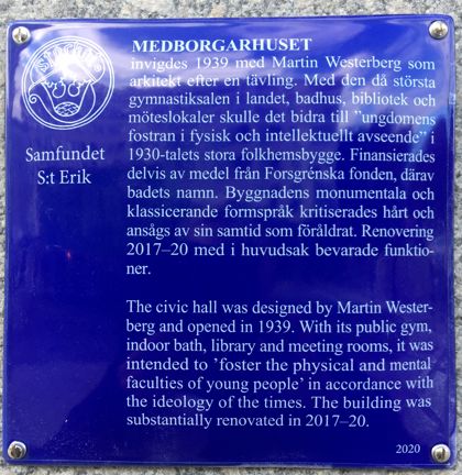 Blå emaljerad skylt med vit text