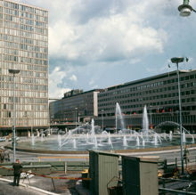 Fontänen vid Sergels Torg, femte hötorgshuset och bankhusen vid Sveavägen. I förgrunden Gatukontorets materiel och redskapsbodar