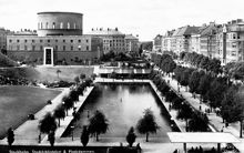 Stockholms stadsbibliotek med den stora dammen i förgrunden. Till höger i bild ligger Sveavägen.