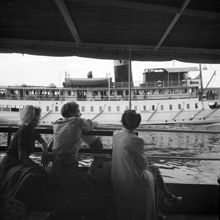 Båtar på Norrström. Passagerare sitter på däck