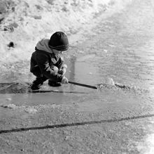 Barn leker i snösmältningen