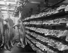 Inför julen 1939 är griskroppar upphängda och styckade på hyllor i slakteri.