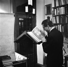 Interiör från Libris antikvariat på Kommendörsgatan 14. Man som studerar gammal bibel