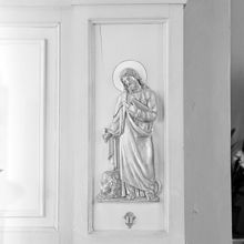Katolska kyrkan. Detalj från sidoaltare föreställande aposteln Marcus med ett lejon