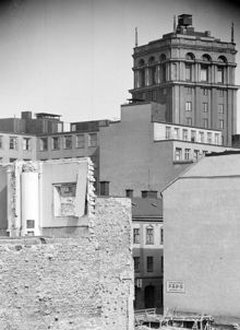 Kv. Uppvaktaren mot Oxtorgsgatan under rivning. I fonden Södra Kungstornet och nedanför det Oxtorgsgatan 16 (byggt 1937). Här ligger nu Sveavägen 22, kv. Putten, under marken finns T-Hötorget