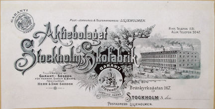 Brevhuvud tryckt i svart med bild på fabrik, dekorationer samt text.