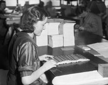 Kvinnor sorterar och kontrollerar motböcker. Bilden är tagen i samband med motbokssystemets 25-år jubileum år 1939.