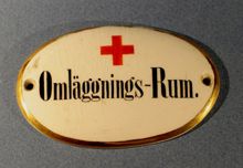 Dörrskylt med text; "Omläggningsrum"