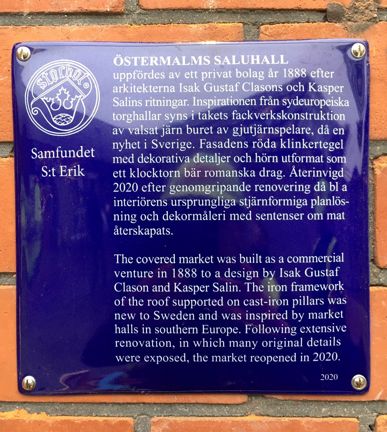 Blå emaljerad skylt med vit text