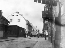 Stora Badstugatan norrut vid korsningen med Rådmansgatan. T. v. kv. Stormkransen och Sjökalven, som revs för att ge plats åt Sveavägen. Hölasset är troligen på väg till gården på St. Badstugatan 31